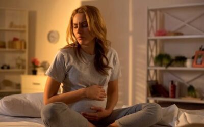 Pregnant woman consulting doctor for high-risk pregnancy monitoring and care