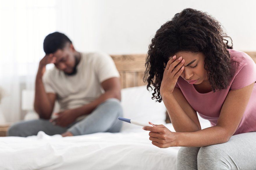 Woman feeling stressed after negative pregnancy test highlighting infertility concerns