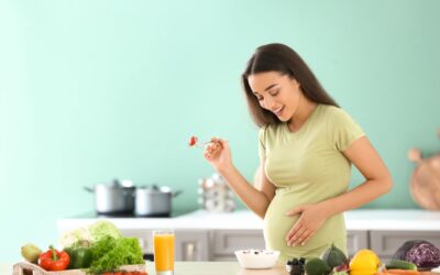 Happy pregnant woman holding her belly showing a healthy and positive pregnancy journey