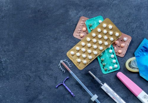 birth control pills and fertility concept woman planning pregnancy